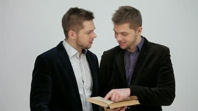 stock footage twins are reading a book together