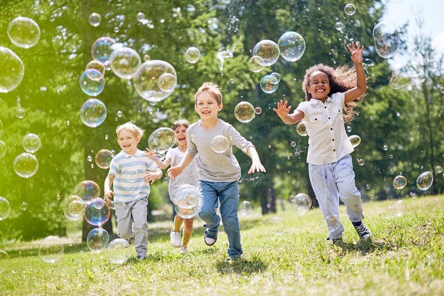 kids playing bubbles istock 0