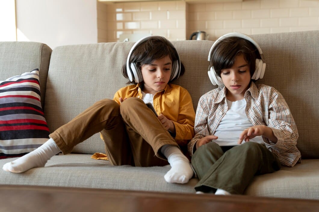 little twins playing their tablet 23 2149126701