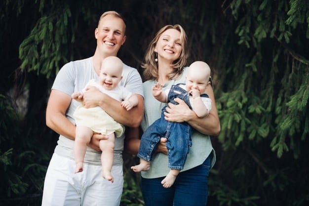 happy family with twins boy girl laughing posing together outdoors green tree 132075 10455