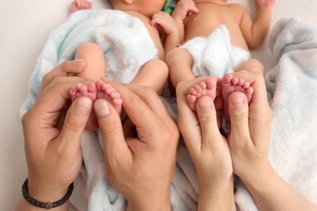 father mother are holding legs newborn twins hands parents feet their children high quality photo 447871 627
