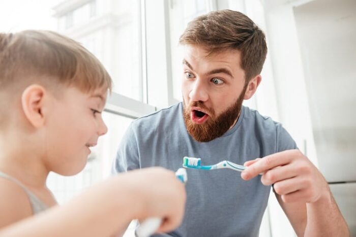 brushing teeth son and father