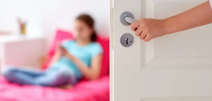 mother hand opening door to girl room.jpg