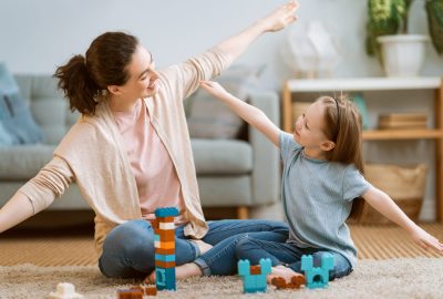 Happy day! Mom and her daughter child girl are playing and smiling. Family holiday and togetherness.